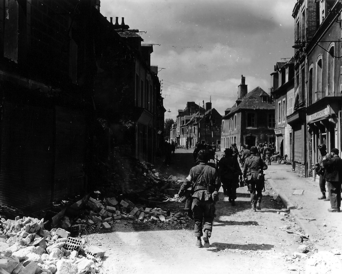 101st Airborne paratroopers patrol the streets of Carentan, June 1944