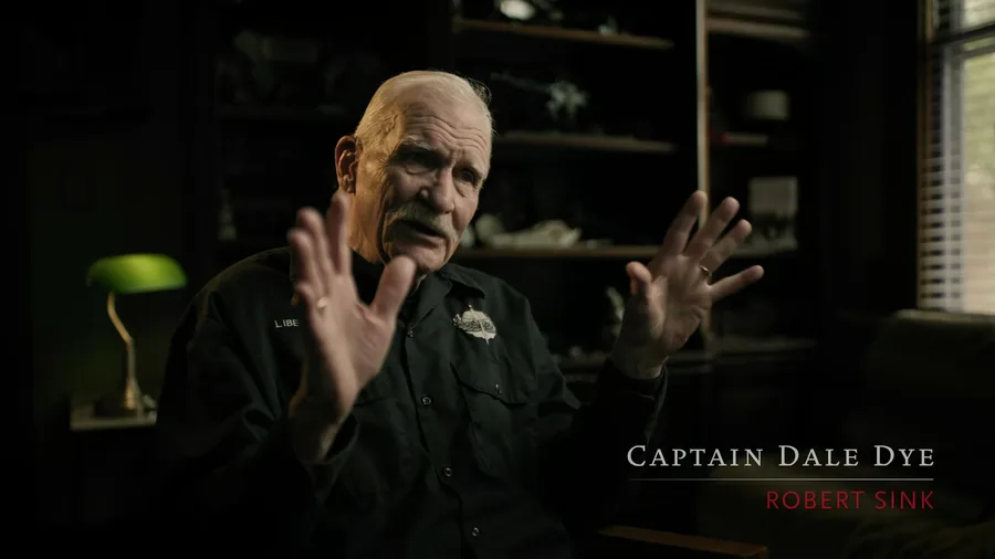 Dale Dye in Band of Brothers: Legacy, captioned on screen as Robert Sink, the role he played.